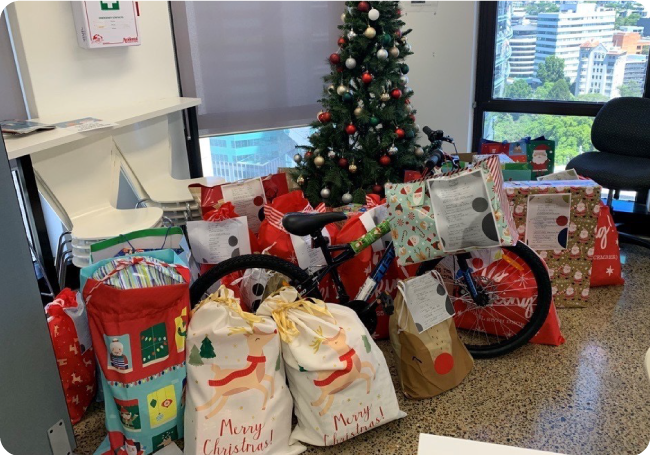 Photo of presents surrounding Christmas tree, donated by Volaris employees for Lighthouse Care's annual Santa’s Helper - Christmas Charity Drive