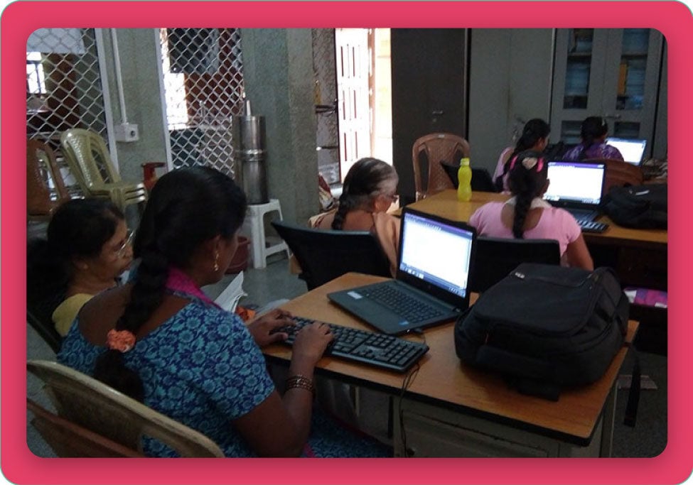 Photo of students in a classroom working on laptops.