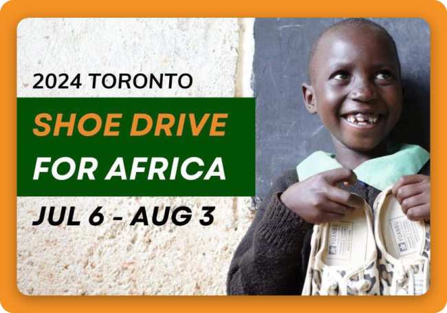 Photo of child holding donated shoes